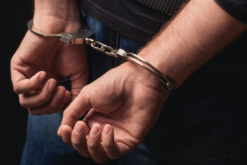 Young man arrested in handcuffs